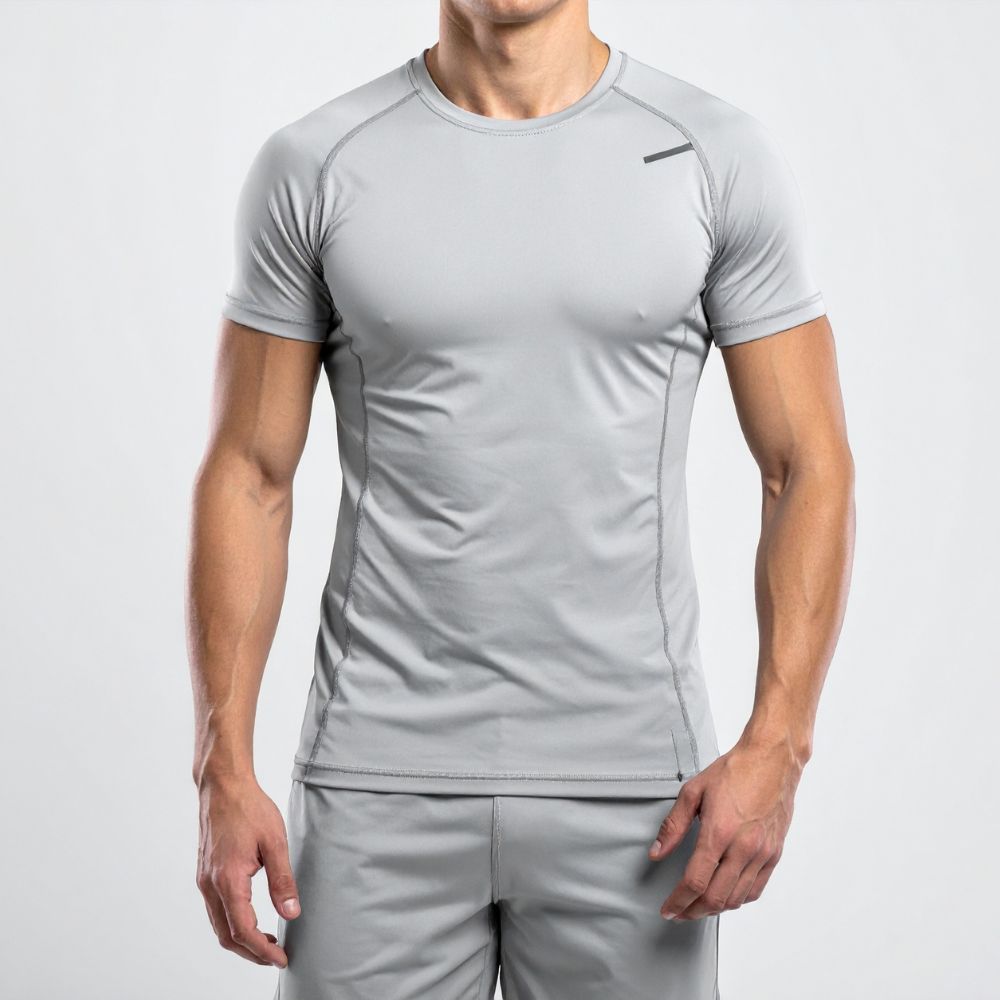 Person wearing a gray athletic outfit on a light gray background